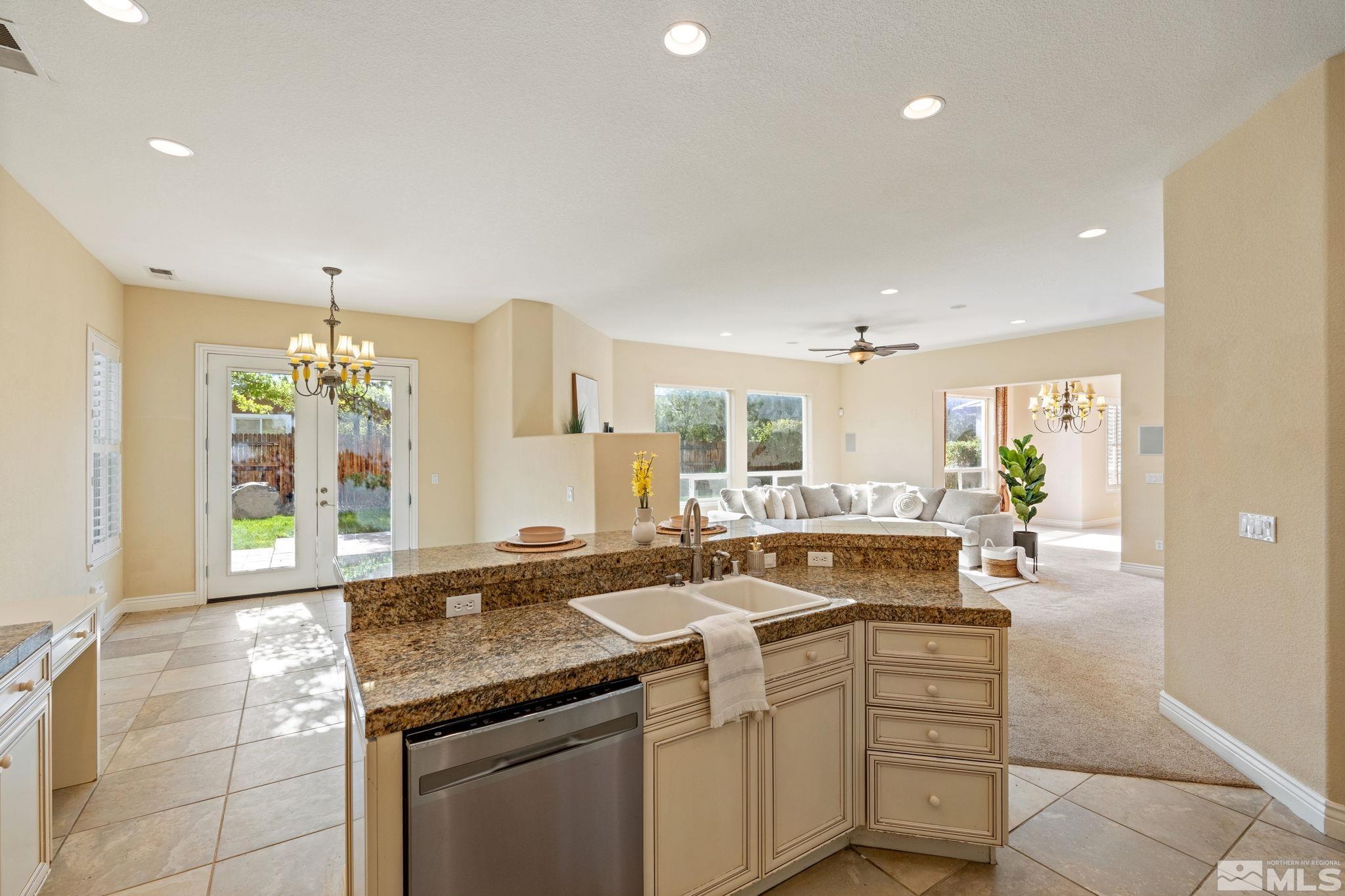 10035 Goler Wash Court Reno, NV 89521 - Photo 22 of 40 a kitchen with granite countertop a sink and cabinets