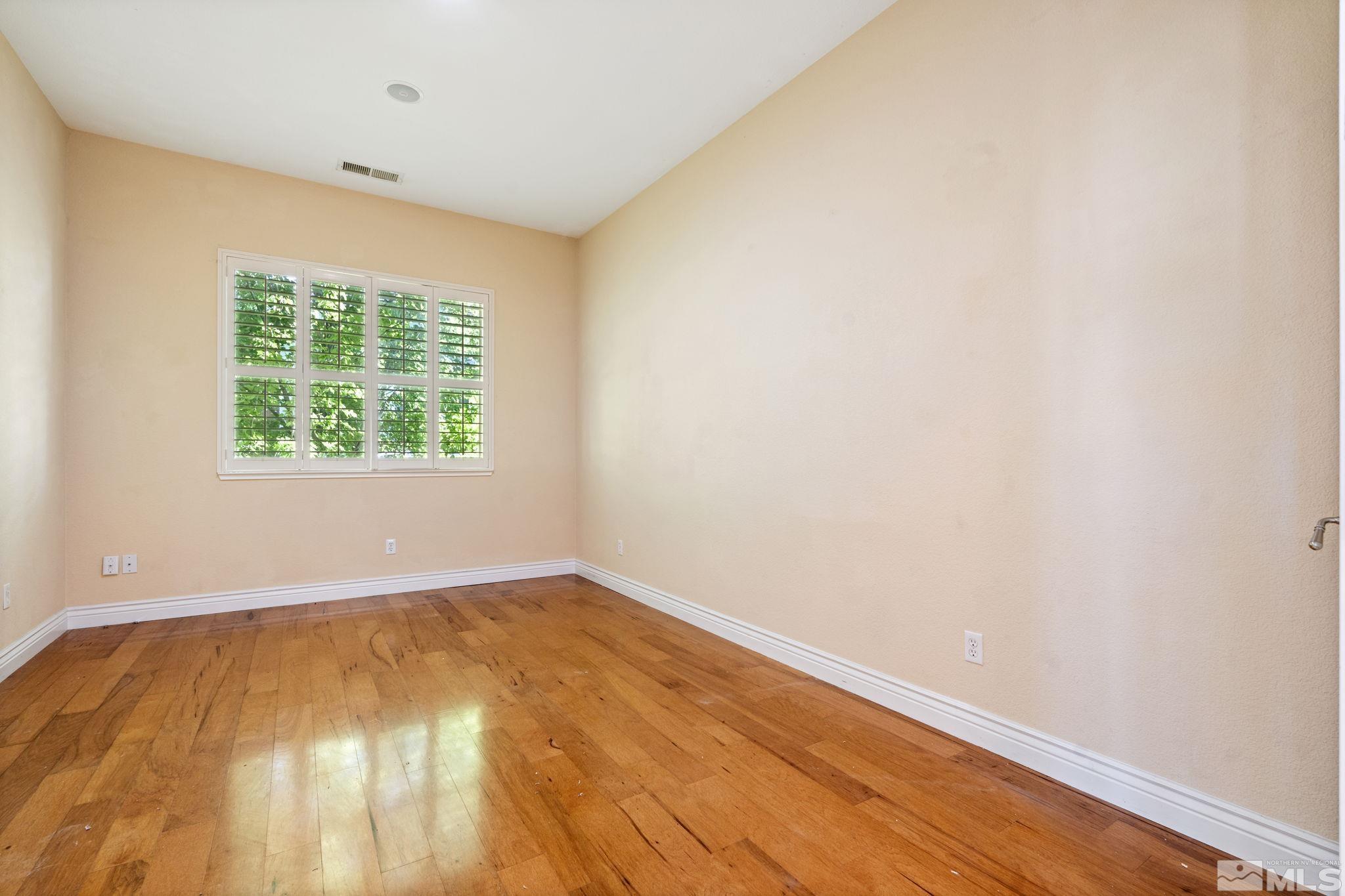 10035 Goler Wash Court Reno, NV 89521 - Photo 27 of 40 an empty room with wooden floor and windows