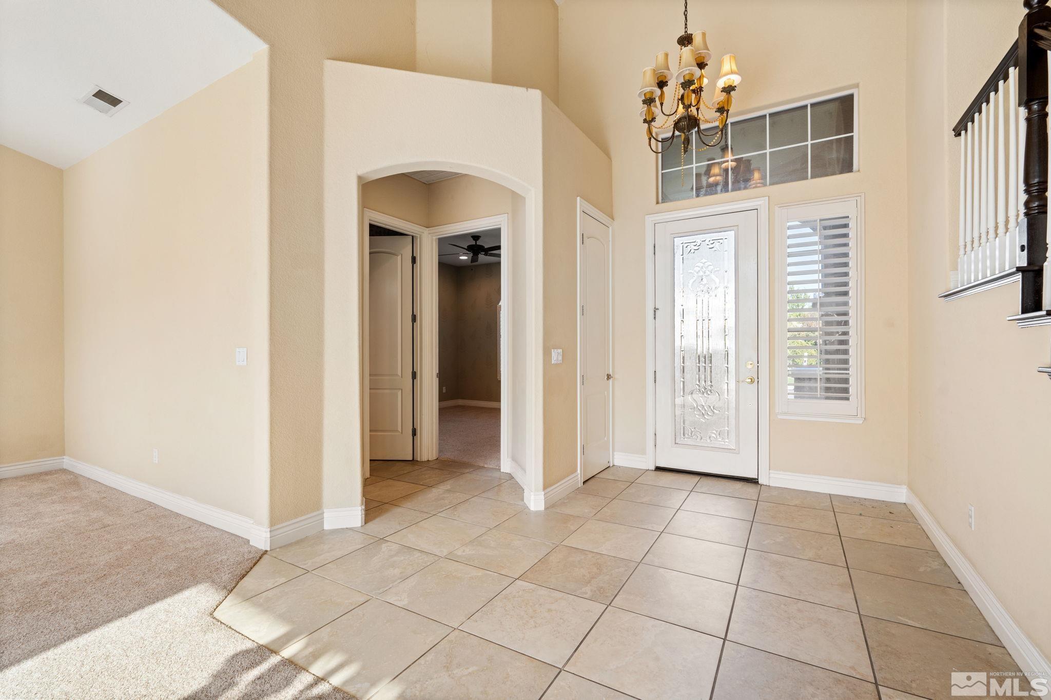 10035 Goler Wash Court Reno, NV 89521 - Photo 28 of 40 a view of a hallway with a chandelier