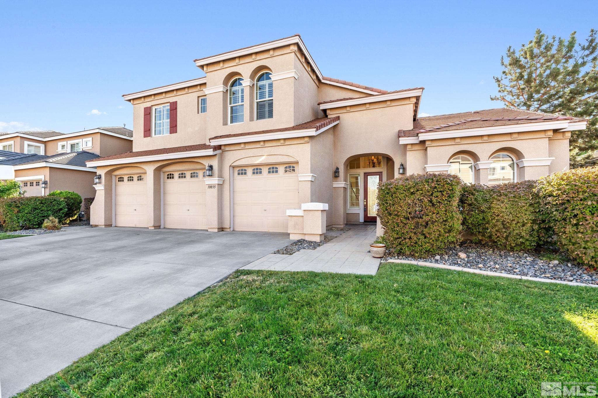 10035 Goler Wash Court Reno, NV 89521 - Photo 3 of 40 a front view of a house with a yard and garage