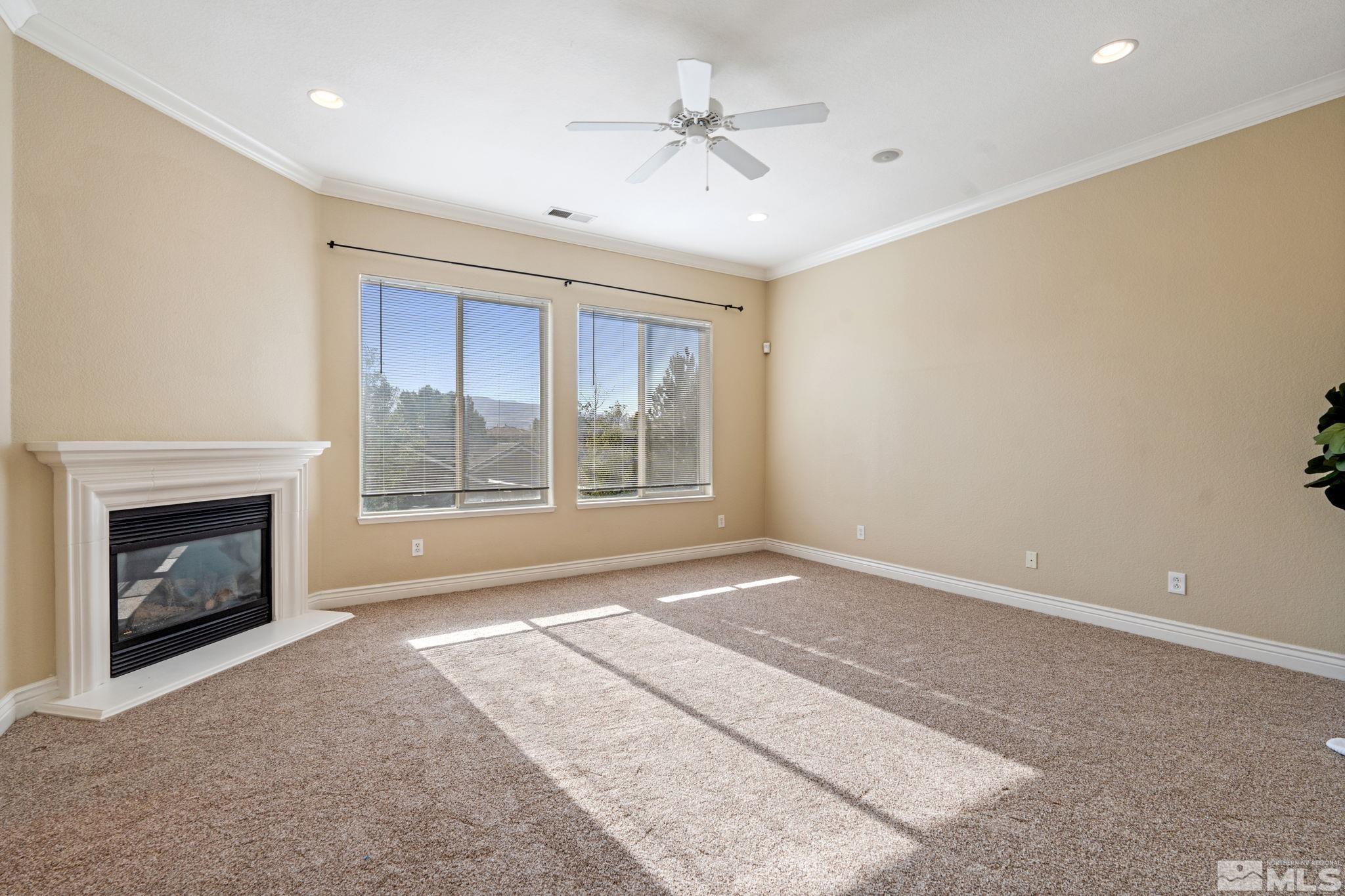 10035 Goler Wash Court Reno, NV 89521 - Photo 32 of 40 a view of an empty room with a fireplace and a window