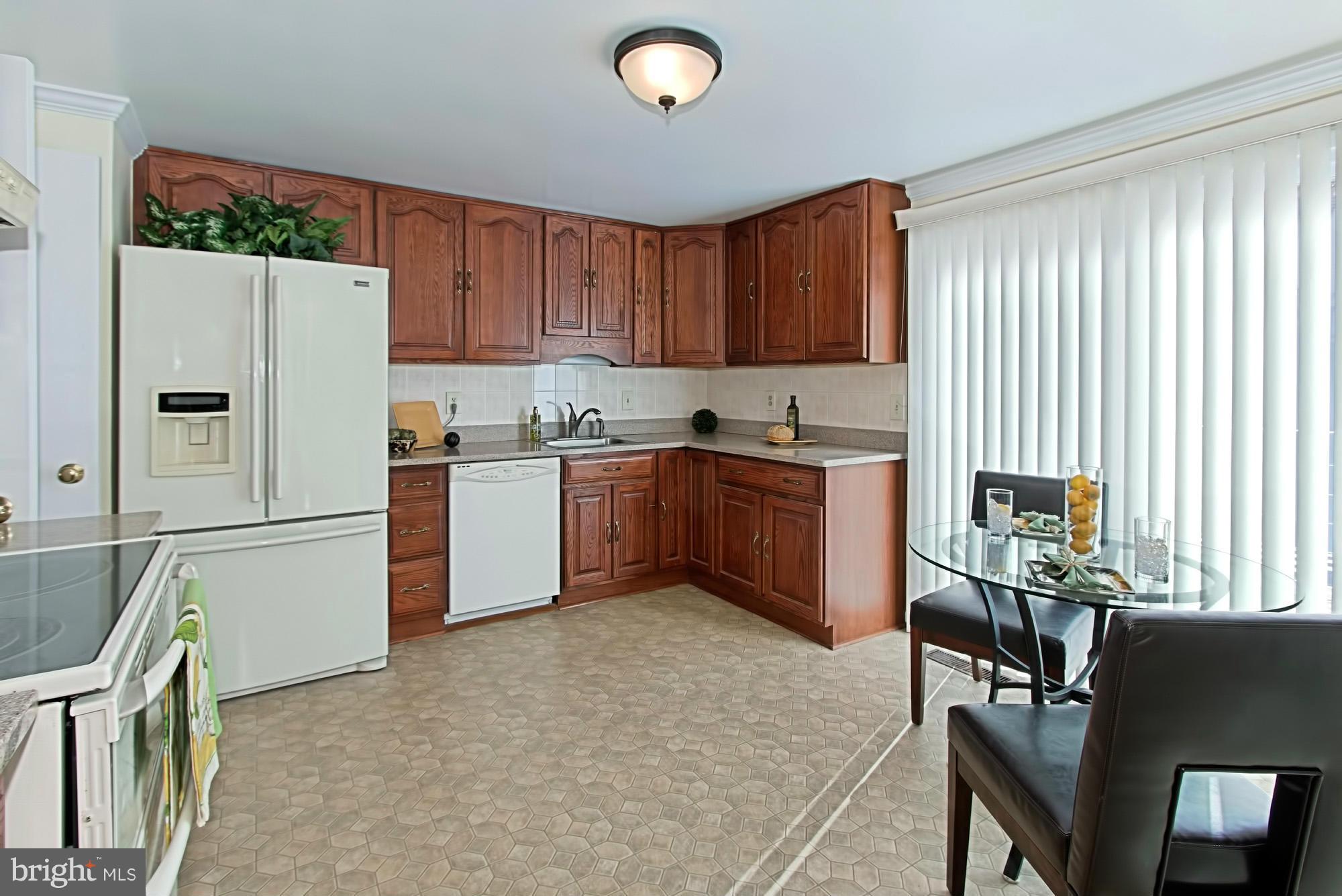 9505 Burning Branch Road Burke, VA 22015 - Photo 11 of 30 a kitchen with stainless steel appliances granite countertop a refrigerator sink and cabinets