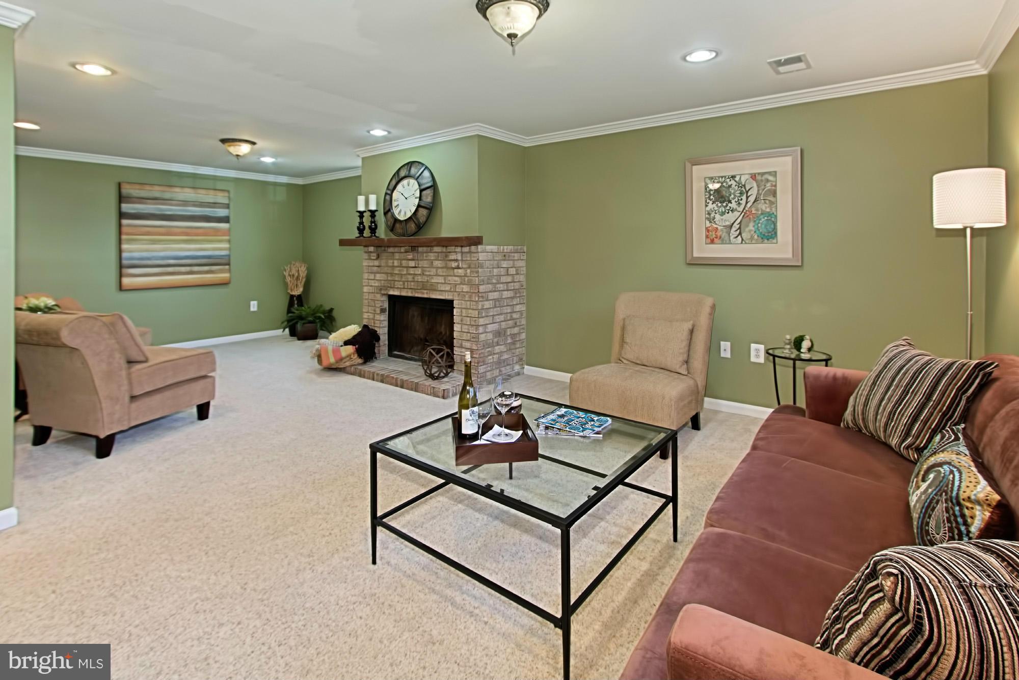 9505 Burning Branch Road Burke, VA 22015 - Photo 23 of 30 a living room with furniture and a fireplace