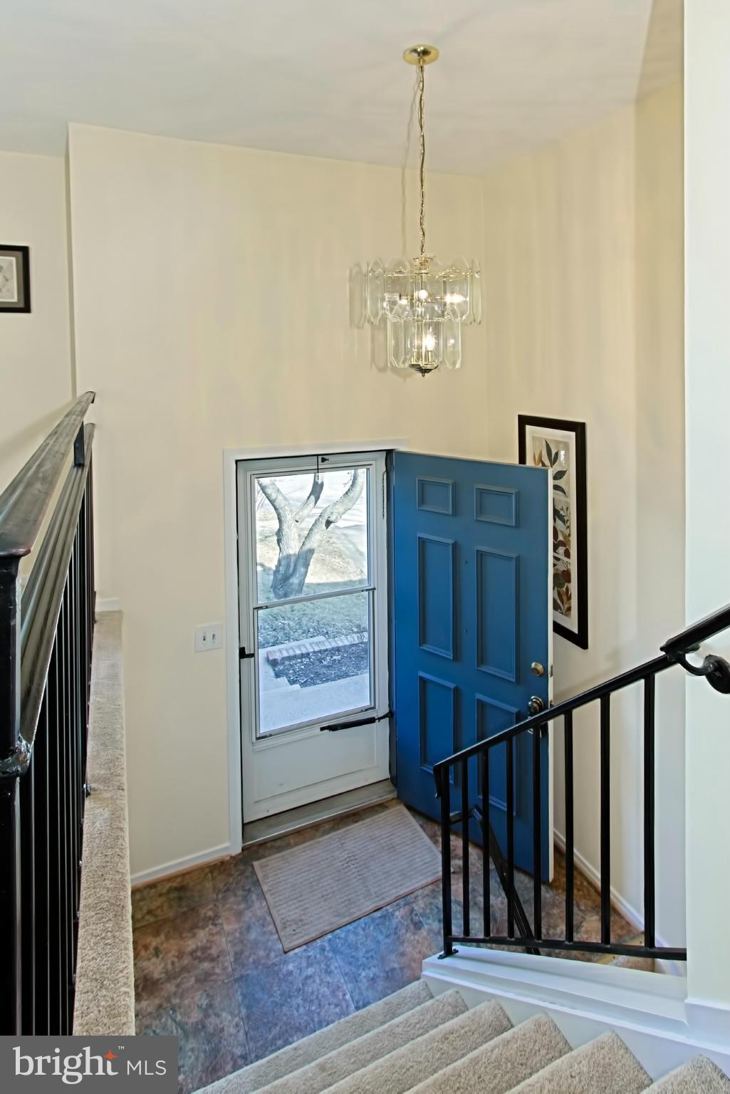 9505 Burning Branch Road Burke, VA 22015 - Photo 4 of 30 a view of a livingroom with wooden floor and stairs