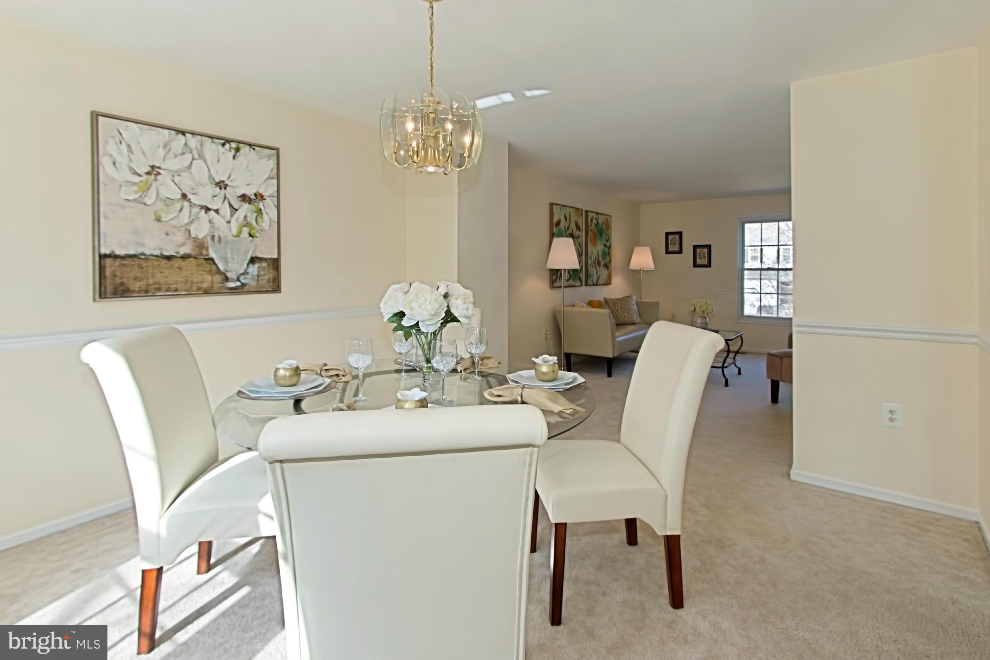 9505 Burning Branch Road Burke, VA 22015 - Photo 10 of 30 a dining room with furniture and chandelier