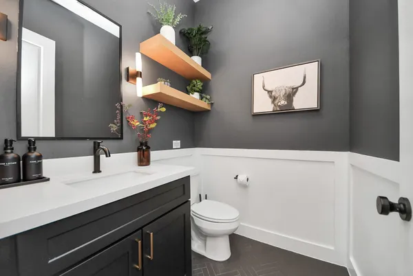 a kitchen with stainless steel appliances kitchen island granite countertop a sink a stove a dining table and chairs