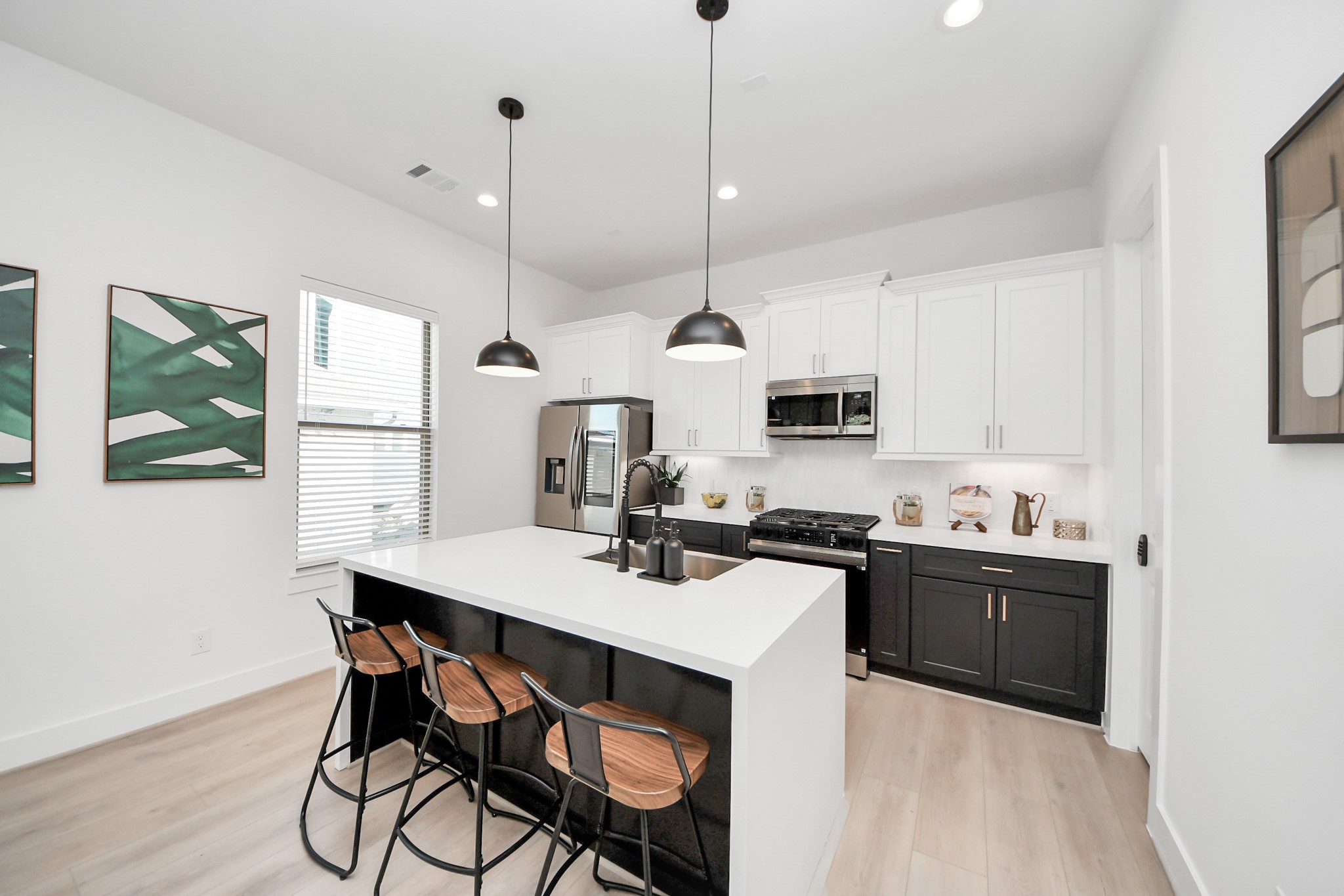 2524 Live Oak Street Houston, TX 77004 - Photo 16 of 50 a kitchen with stainless steel appliances kitchen island granite countertop a sink a stove a dining table and chairs