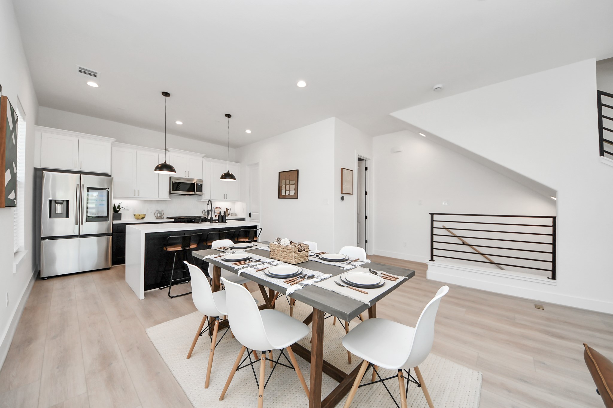2524 Live Oak Street Houston, TX 77004 - Photo 20 of 50 a kitchen with stainless steel appliances kitchen island granite countertop a kitchen island a stove a table and chairs