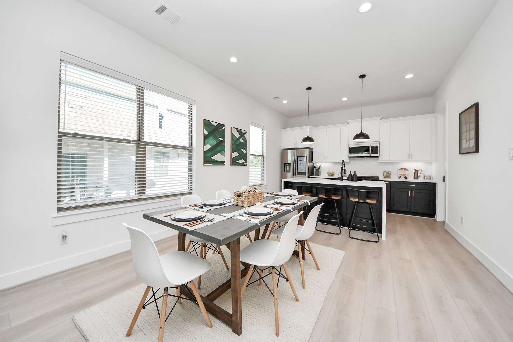 2524 Live Oak Street Houston, TX 77004 - Photo 21 of 50 a kitchen with stainless steel appliances kitchen island a table chairs sink and cabinets