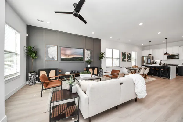 a living room with furniture and a potted plant