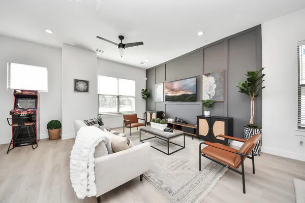 a living room with furniture and wooden floor