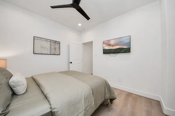 a bathroom with a toilet a sink a mirror a bathtub and vanity