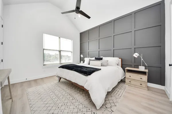 a bedroom with a bed and a painting on the wall