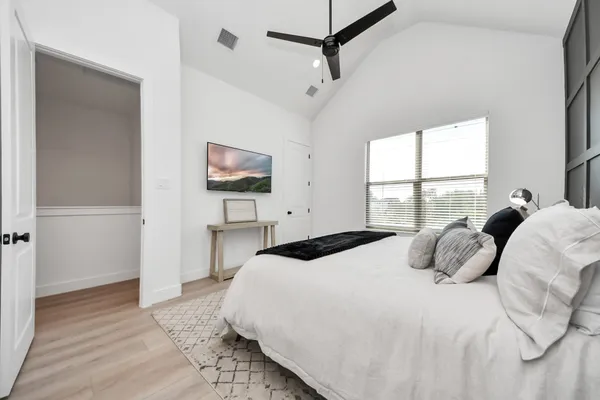 a bathroom with a double vanity sink a mirror and a bathtub