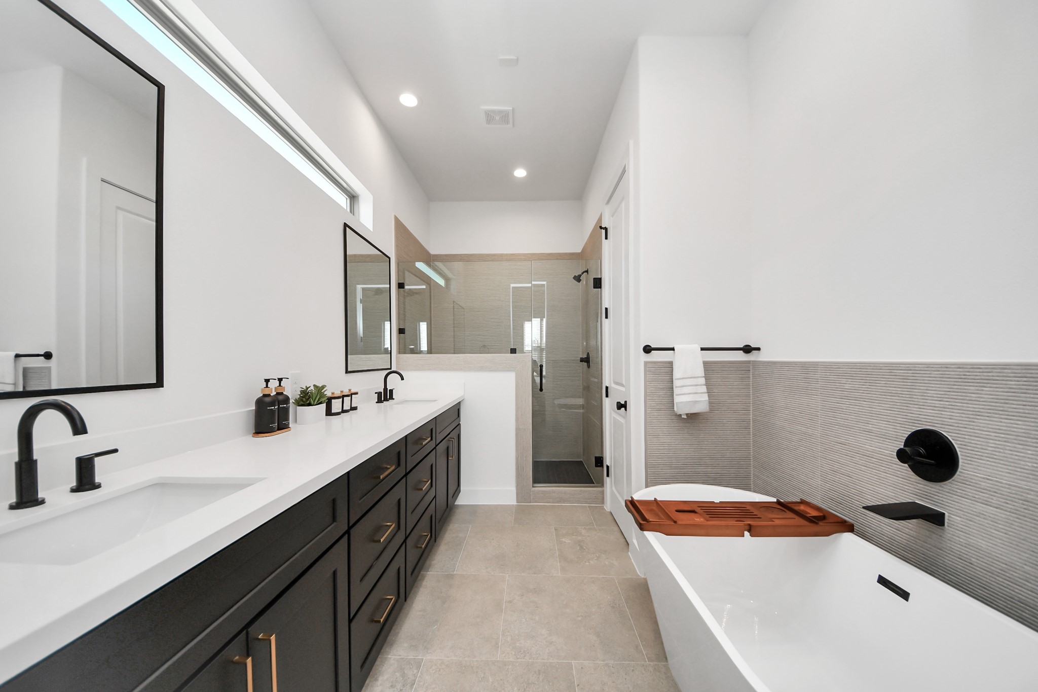 2524 Live Oak Street Houston, TX 77004 - Photo 43 of 50 a bathroom with a double vanity sink a mirror and a bathtub