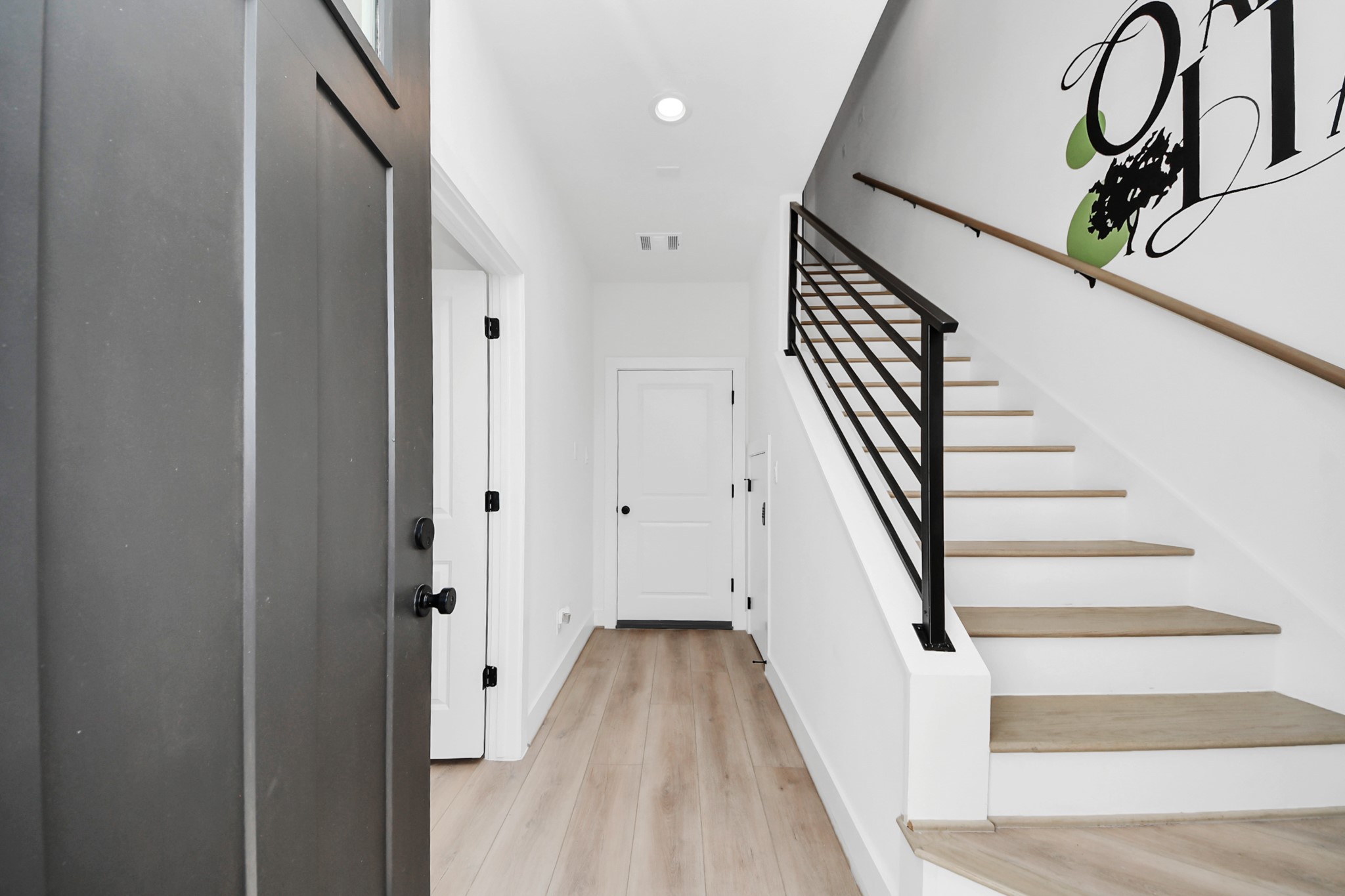 2524 Live Oak Street Houston, TX 77004 - Photo 7 of 50 a view of a hallway with wooden floor and stairs
