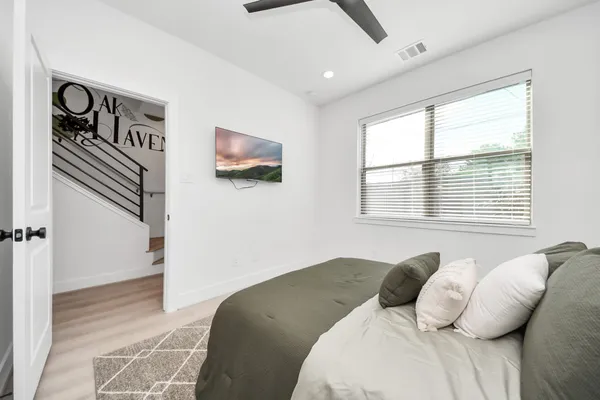 a bedroom with a bed and a chair