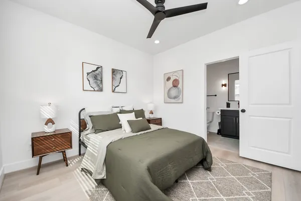 a bedroom with a bed and painting on the wall