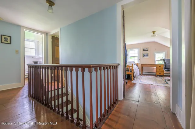 a view of a hallway to a livingroom with furniture