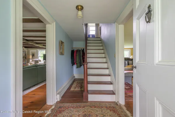 a view of a hallway with wooden floor and entryway