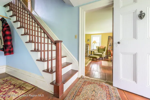 a view of entryway and hall with wooden floor