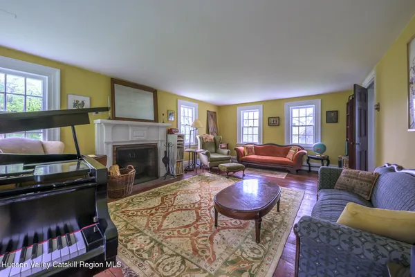 a living room with furniture a flat screen tv and a fireplace