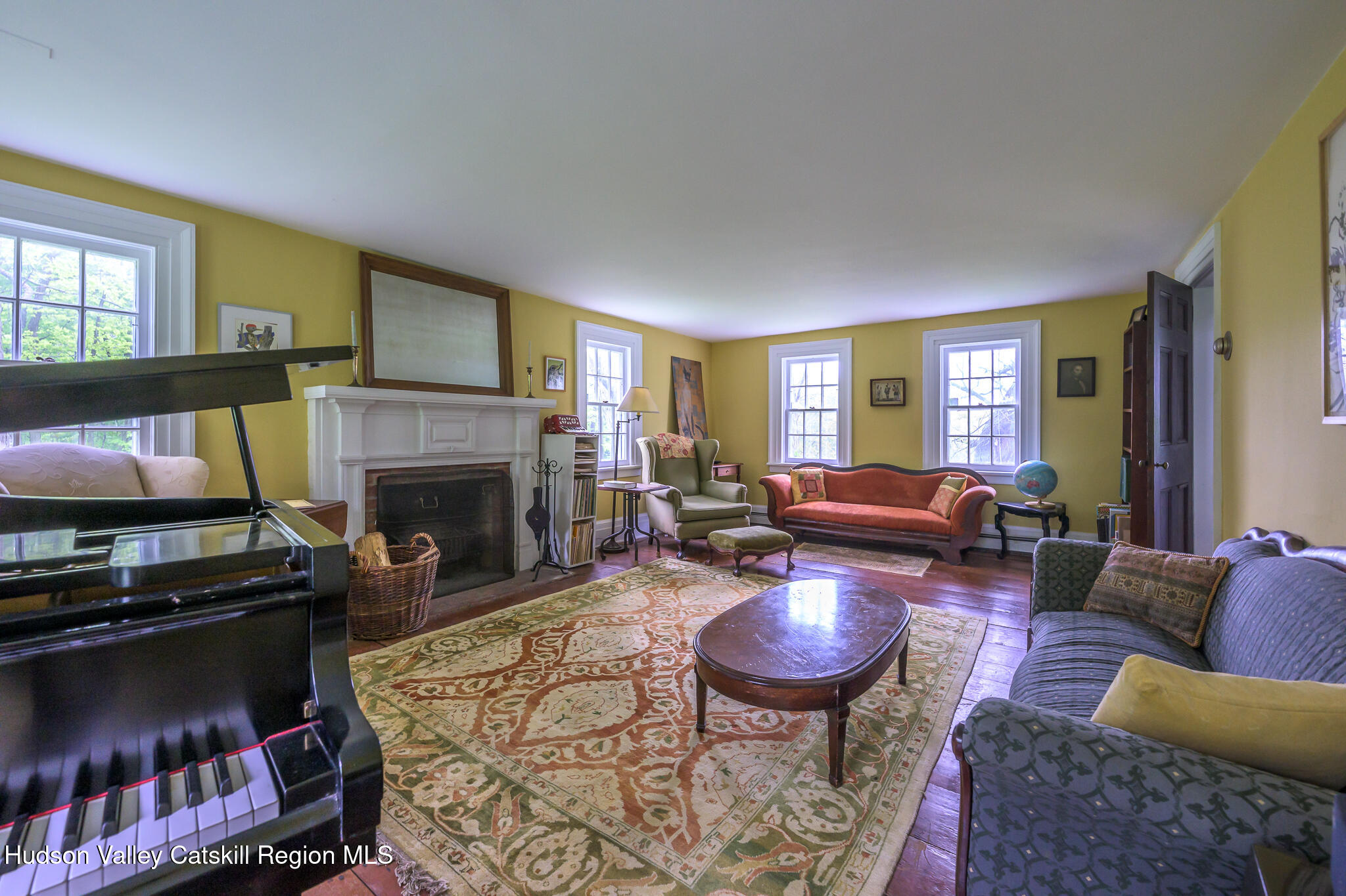1250 County Rte 351 Rensselaerville, NY 12147 - Photo 6 of 26 a living room with furniture a flat screen tv and a fireplace