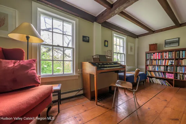 a livingroom with workspace and a window