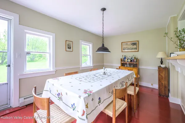 a view of a dining room with furniture window and wooden floor