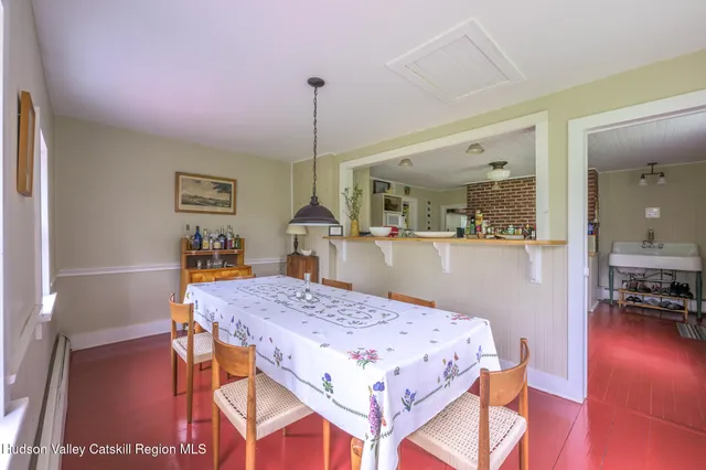 a living room with a table and chairs