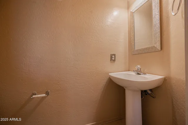 a bathroom with a sink a mirror and a shower