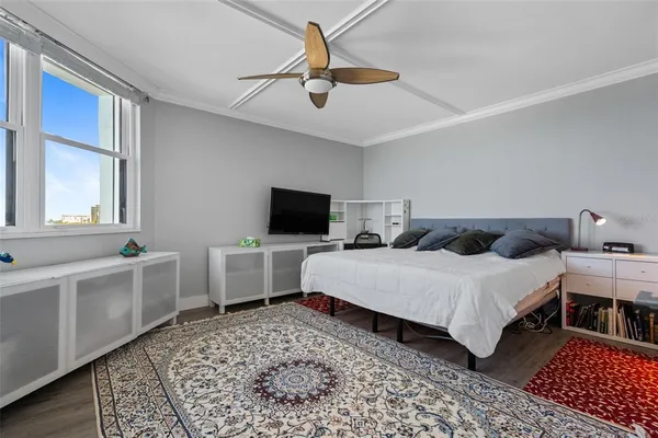 a bed room with a bed and a television