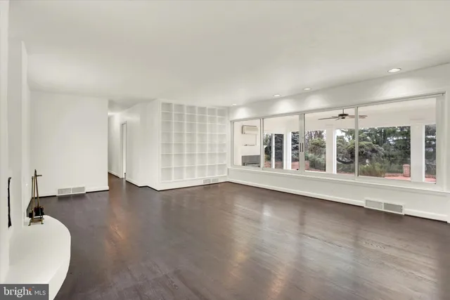 wooden floor in an empty room with a window