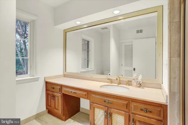 an empty room with wooden floor and ceiling fan