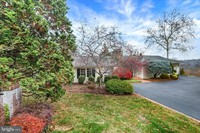 a large kitchen with stainless steel appliances granite countertop a stove a sink and a granite counter tops