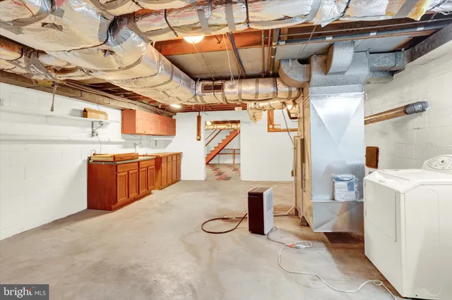 a kitchen with a refrigerator sink and cabinets