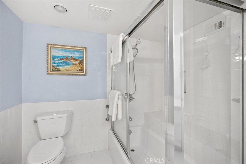 21702 Ocean Vista Drive, Unit B Laguna Beach, CA 92651 - Photo 29 of 47 Shower in tub with built-in bench and glass enclosure.