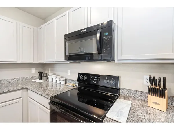 a kitchen with a stove and cabinets