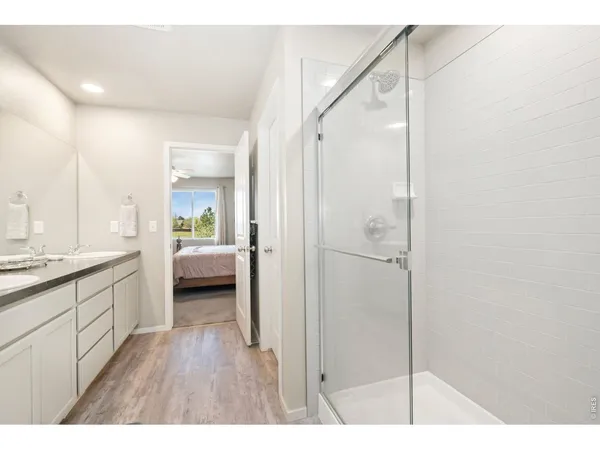 a en suite bathroom with a sink a mirror and a shower