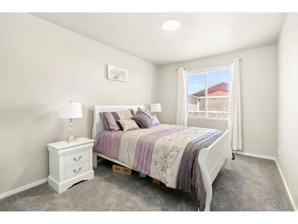 a spacious bedroom with a bed and a cabinets