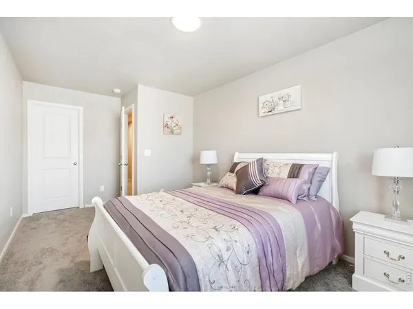 a bedroom with a bed and a lamp