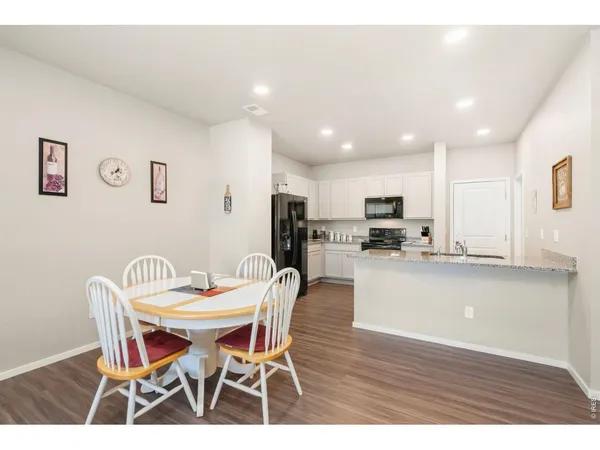 a view of a dining room with furniture and wooden floor