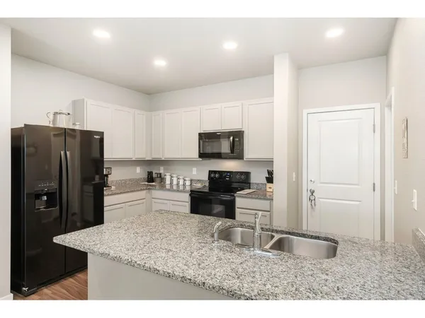 a kitchen with refrigerator and microwave