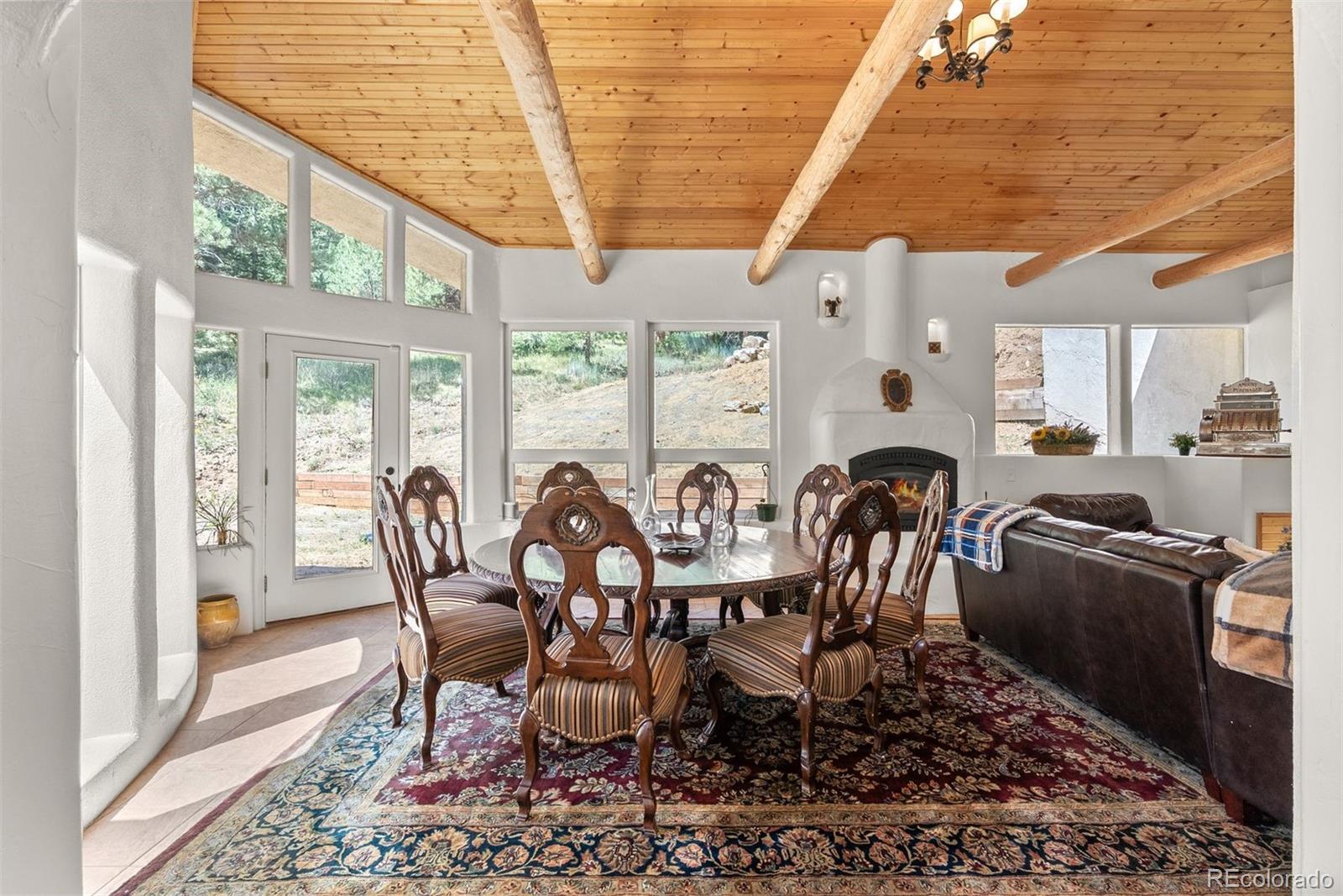 1053 Red Moon Road Evergreen, CO 80439 - Photo 25 of 50 a dining room with furniture a rug and wooden floor