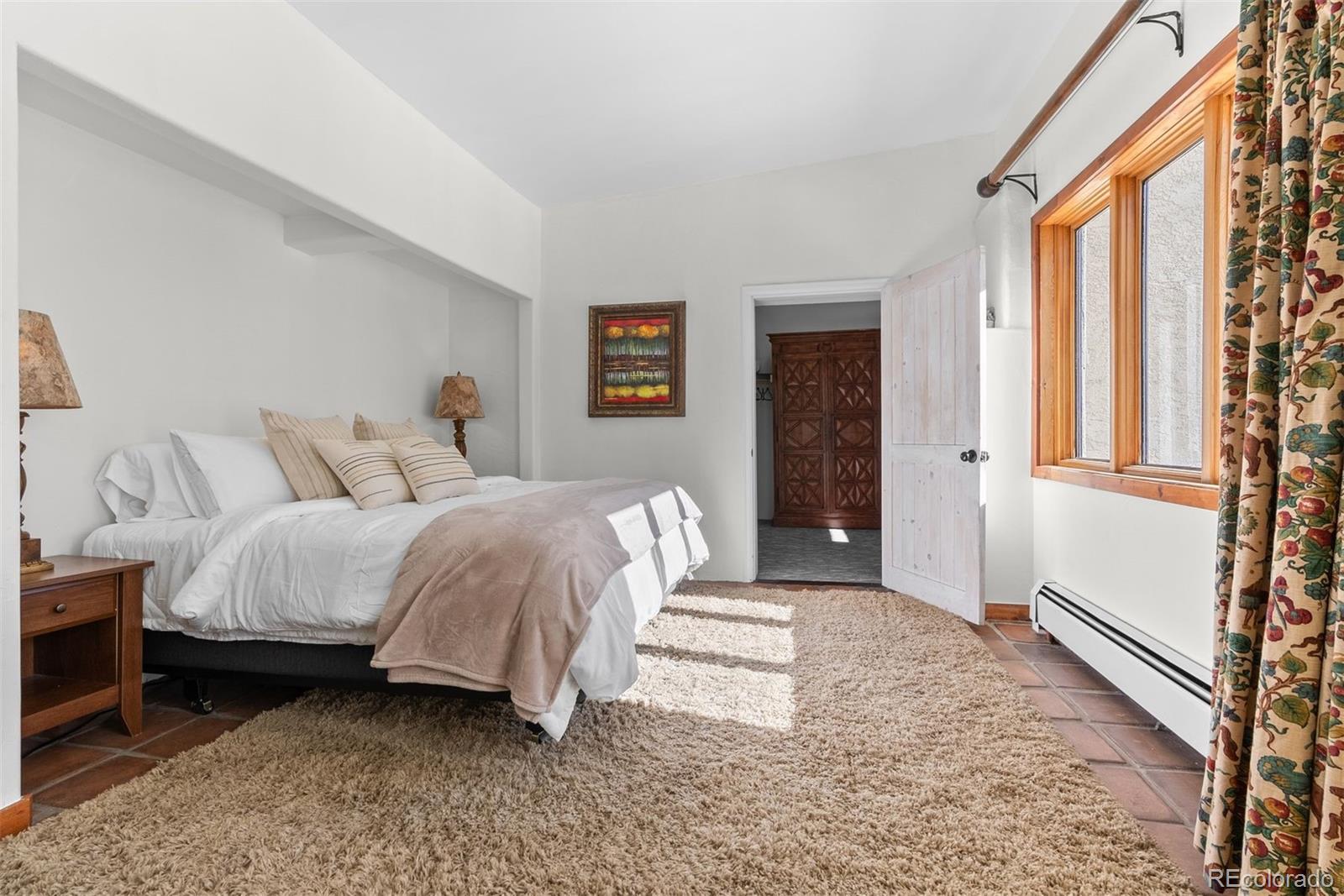 1053 Red Moon Road Evergreen, CO 80439 - Photo 35 of 50 a spacious bedroom with a bed and a window