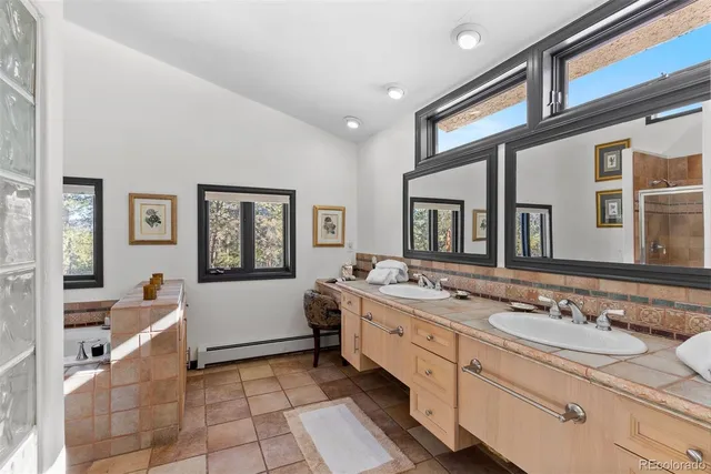 a spacious bathroom with a sink a mirror and shower