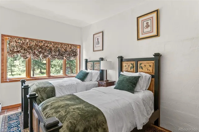 a bedroom with a bed and a large window