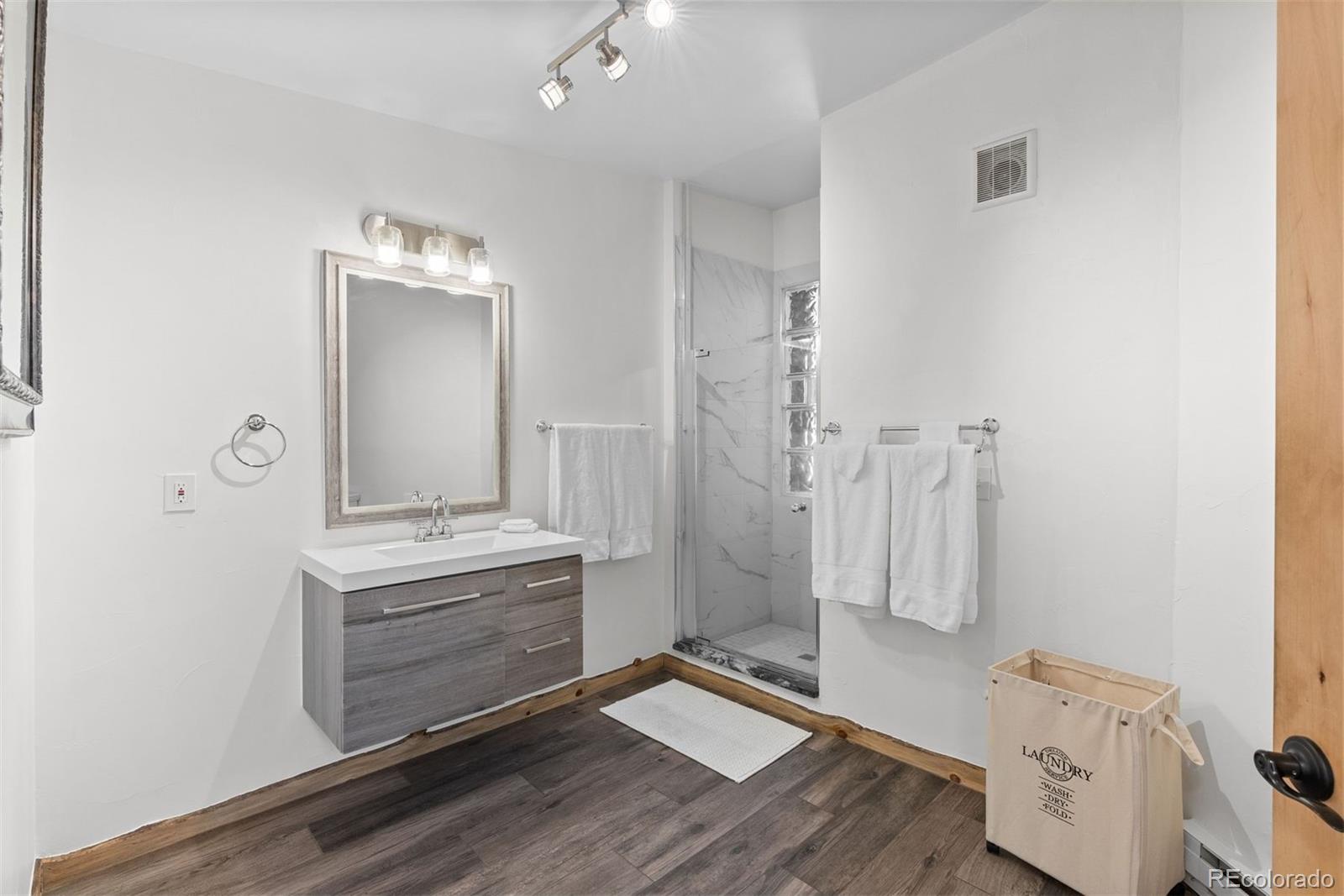 1053 Red Moon Road Evergreen, CO 80439 - Photo 43 of 50 a view of bathroom with a sink mirror and shower