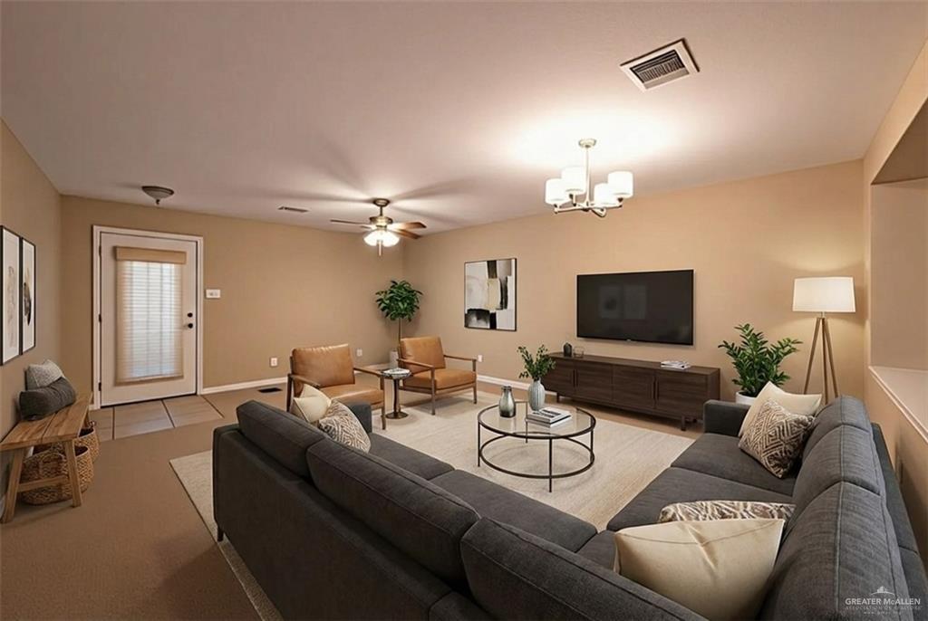 906 East Solar Drive Mission, TX 78574 - Photo 16 of 18 a living room with furniture a chandelier and a flat screen tv