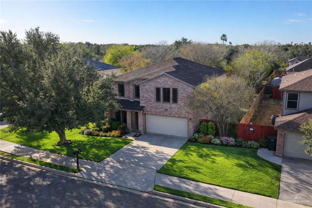 906 East Solar Drive Mission, TX 78574 - Photo 17 of 18 a front view of a house with a yard and potted plants